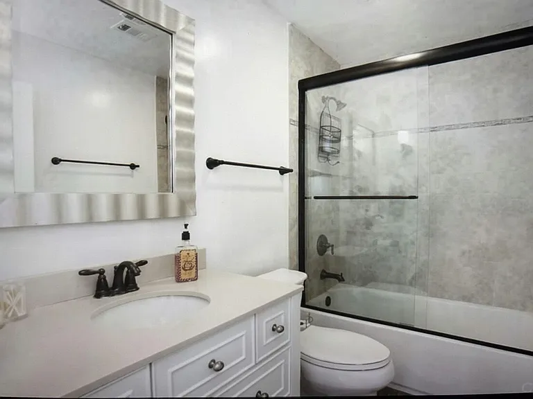 Spa-like bathroom-vanity with ample storage, soaking tub with integrated shower.