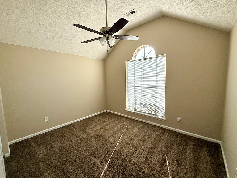 Secondary bedroom w/recently added carpet and ceiling fan/light