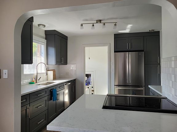 new kitchen with quartz countertops and new stainless appliances