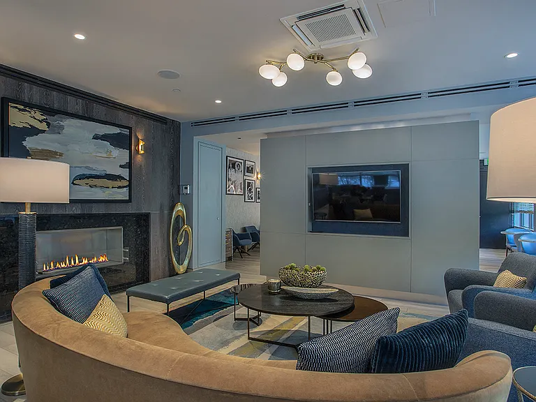 Cozy Seating and a Wide Screen TV in the Club Lounge