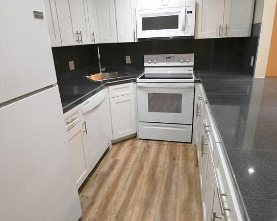 Remodeled kitchen with granite countertop.