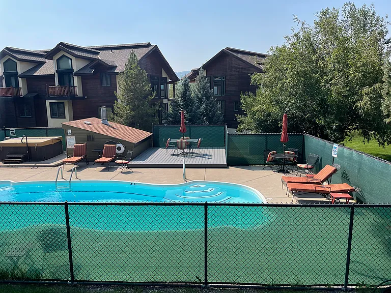 Shared pool and hot tub area right across walkway from condo
