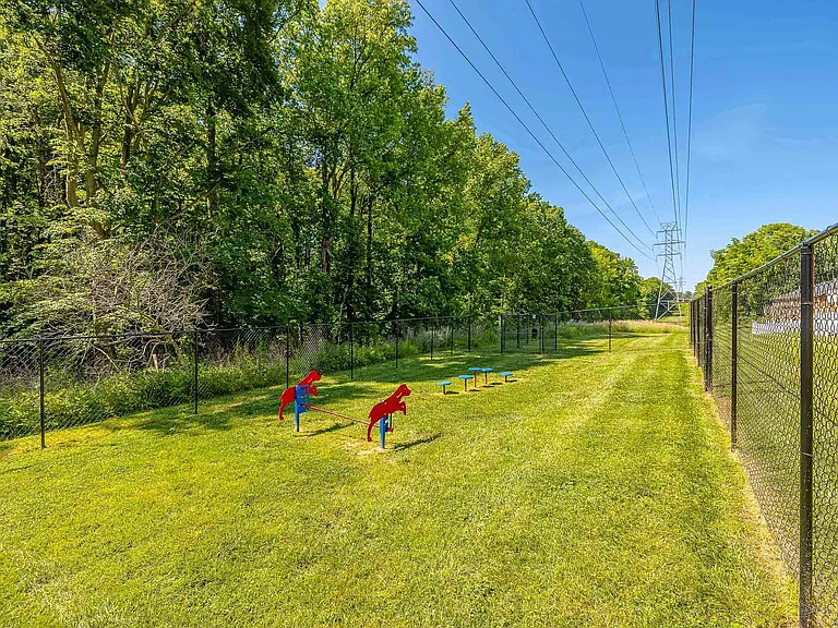 Spacious fenced dog park with open green spaceperfect for daily exercise, off-leash play, and pet-friendly apartment living.