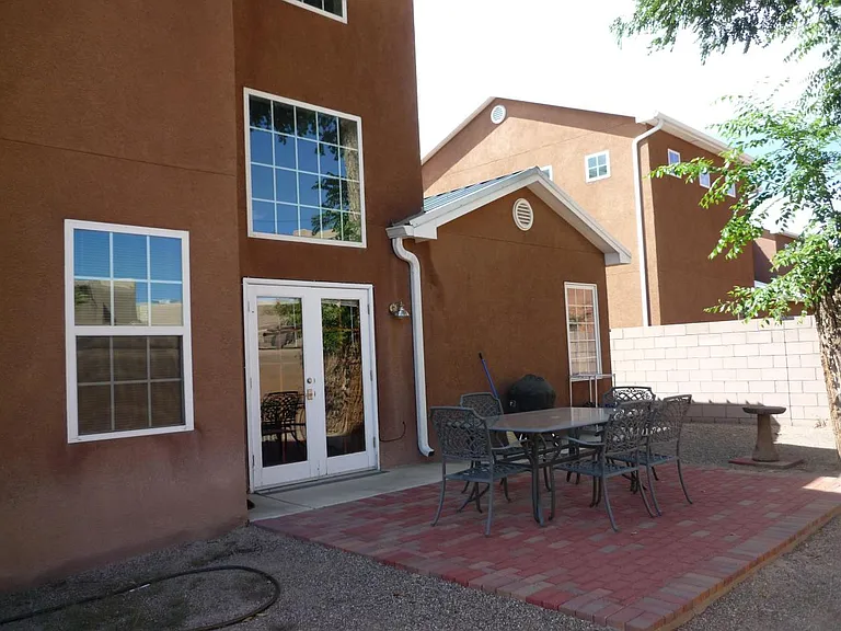 Outdoor Patio with Grill and Dining Table for 6 persons. Walled in backyard with two lockable gates.