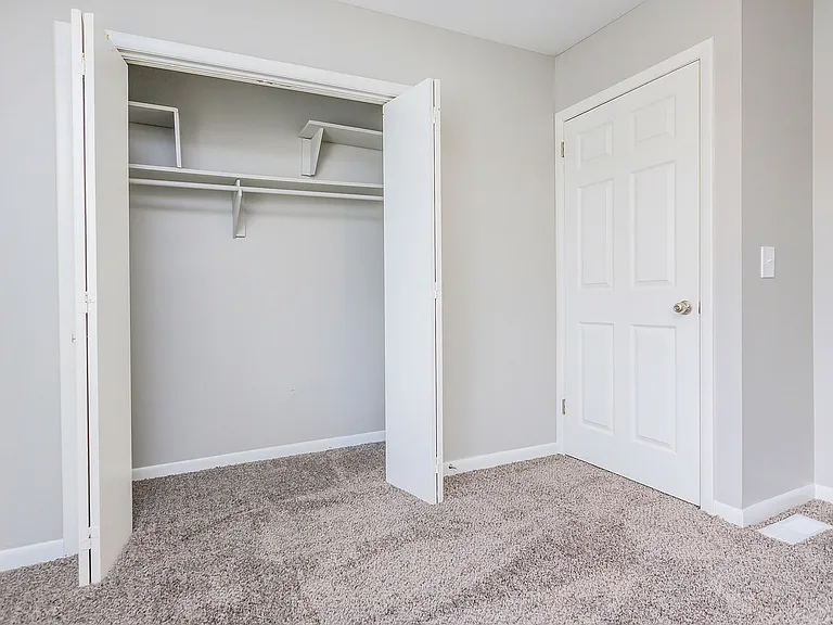 Bedroom with carpet and generous closet space