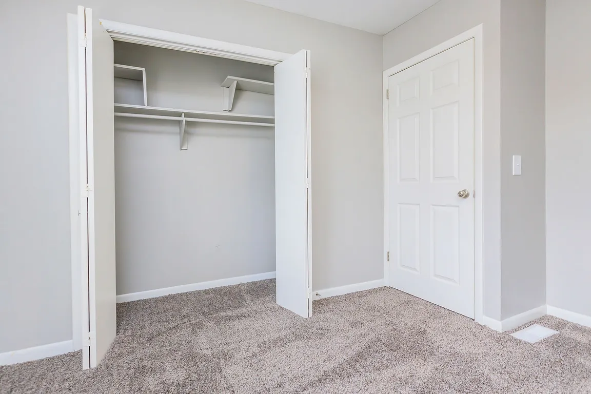 Bedroom with carpet and generous closet space