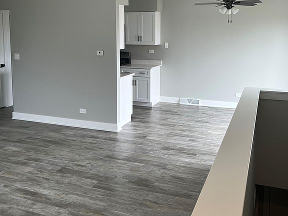 Standing at the top of the stairs looking into living room, dining room and kitchen.