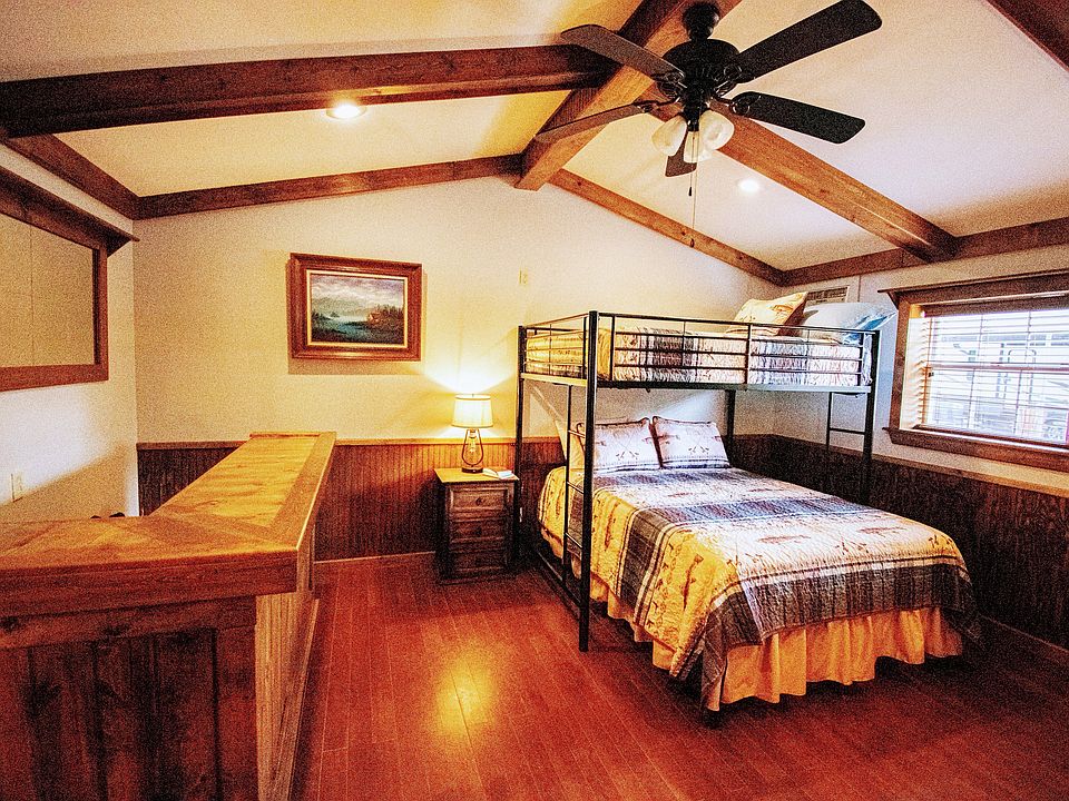 Comfortable queen bed with a full size bed in the loft. The room also has blackout blinds, upright dresser, desk, end tables and lamps. Room is much bigger than it looks in this picture.