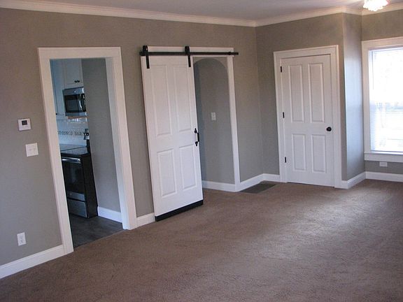Large living room has a unique sliding door into 3rd bedroom/dining room/office.