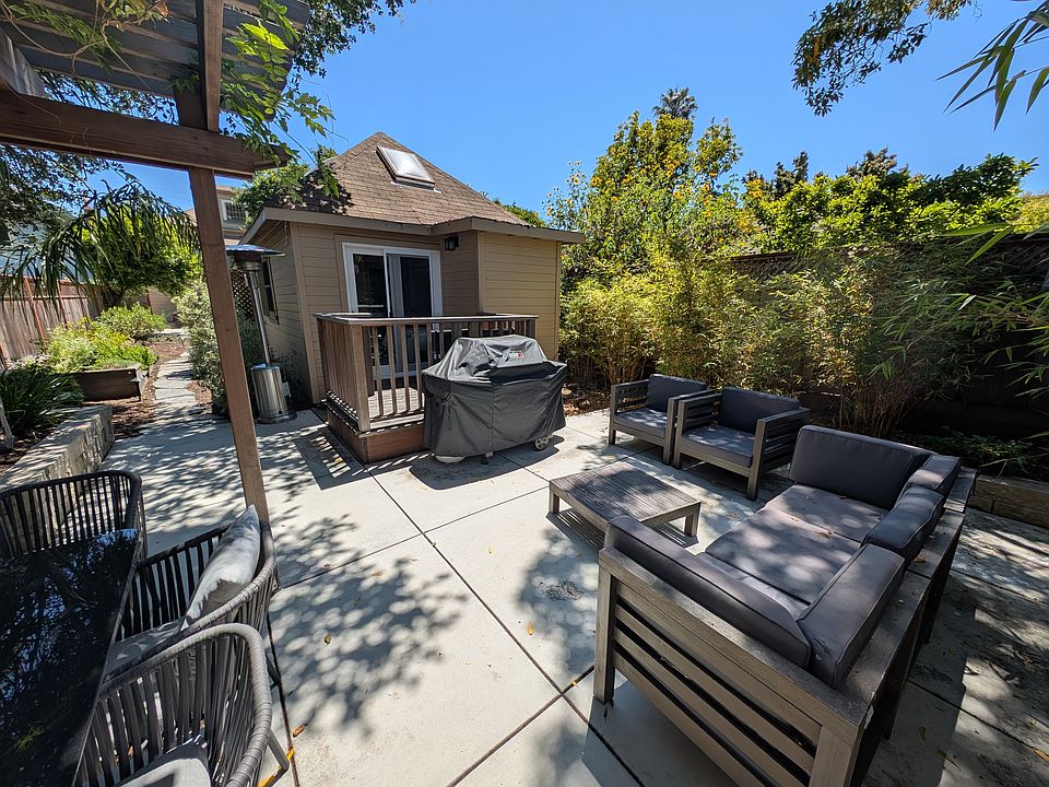 Backyard space with trellis and outdoor furniture