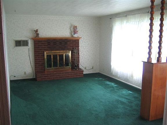 Living Room off of Front Entry with Swamp Cooler and Fireplace