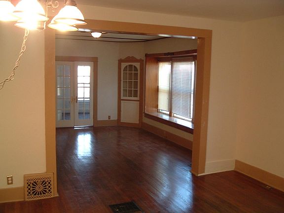 Living/Dinning Room, Bedroom through the doors at the back.