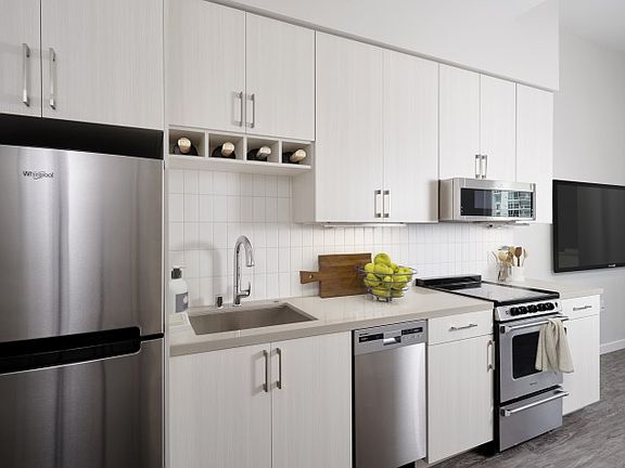Stainless steel appliances, quartz countertops and wine storage