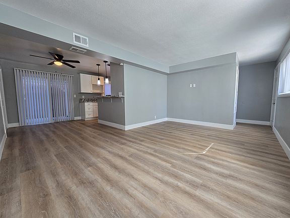 Living room and Dining area. Sliding door exits to private backyard