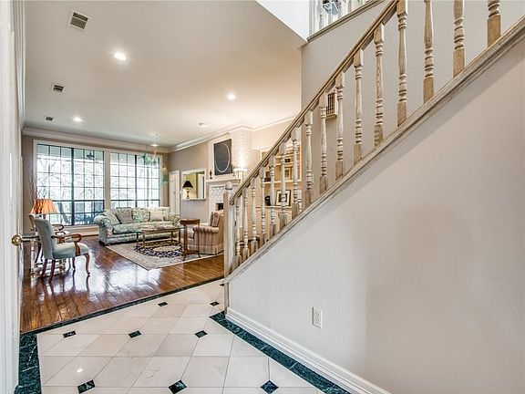View of large, open Living area with view of covered patio and trees.
