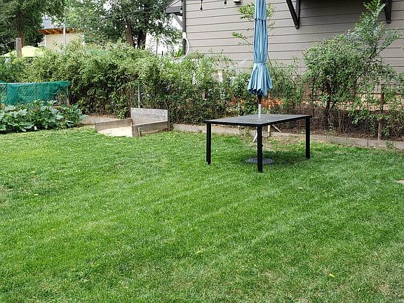 Yard area with raised beds and horseshoe pit
