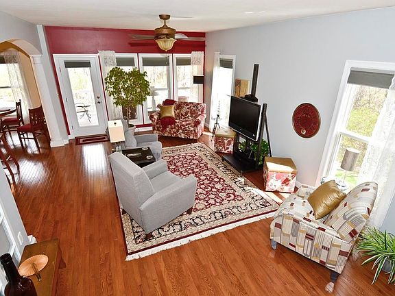 View of great room with arched opening leading to kitchen and breakfast room
