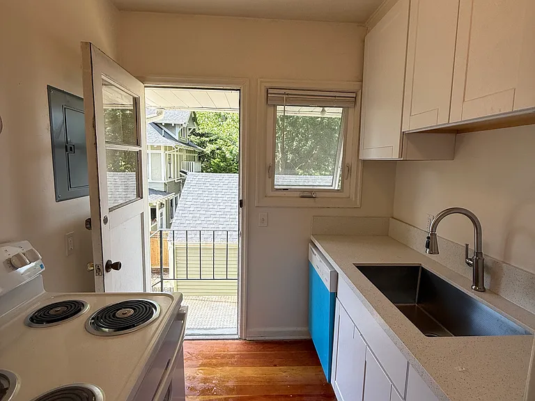 Kitchen with private back door and balcony.