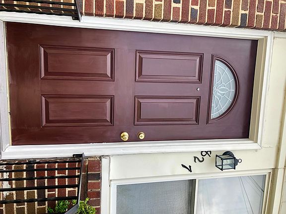 Brick staircase leading to front door with double locks, and peep hole lookout.