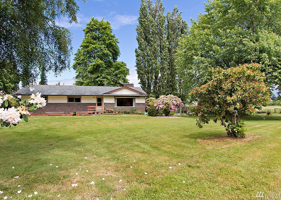 Quality construction with brick & wide plank cedar exterior on level acreage with mountain view