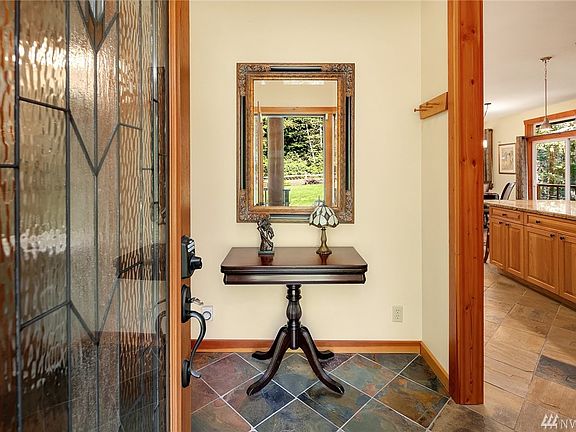 Hello and welcome! Entry foyer gives way to kitchen -- the generous heart of this lovely home -- on the right. with powder room on left, tucked away but convenient.