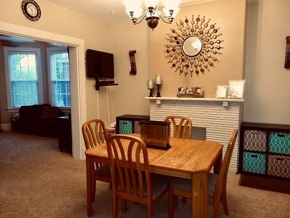 10' ceilings add to the home's charm and space.  A decorative fireplace adorns this spacious dining room which is wide open to t