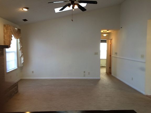 Spacious, airy great room with sky lights, ceiling fan and b