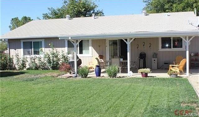 Spacious covered patio and mature rear landscape create a wonder