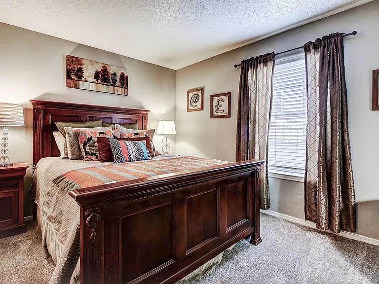 Master bedroom with carpet and lots of natural light