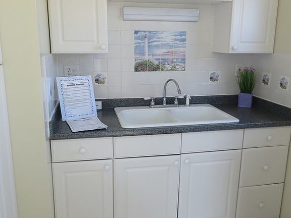 Clean white cabinets with built in pantry to side