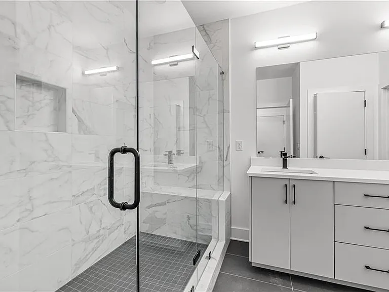 Main Bathroom (Note: Actual unit has light wooden floors and upgraded fixtures / appliances)