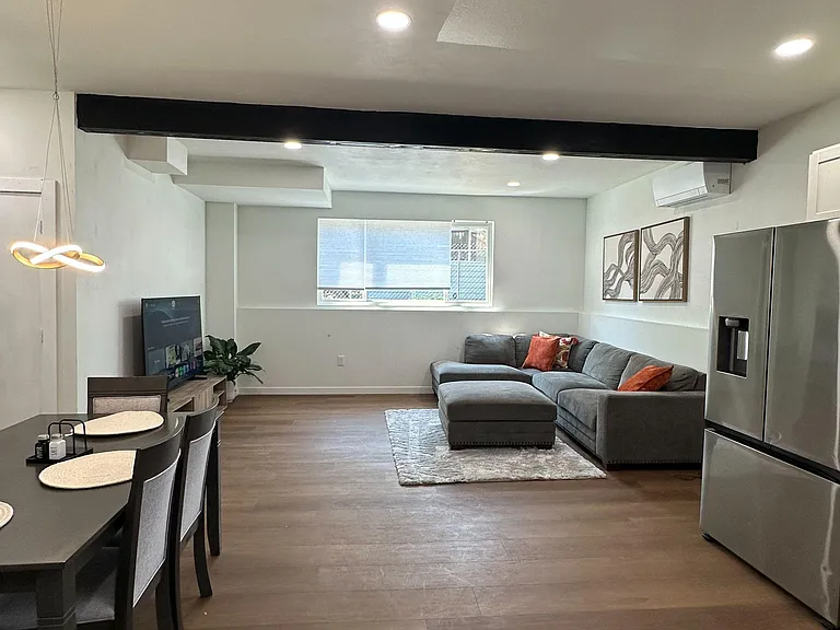 Open-concept living and dining area with recessed lighting, durable flooring, and ample space for relaxing or entertaining.