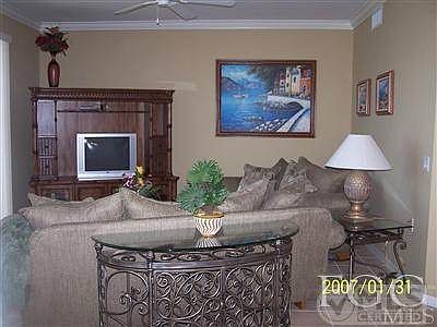 LIVING ROOM WITH STUNNING VIEW OF LAKE AND GOLF COURSE...