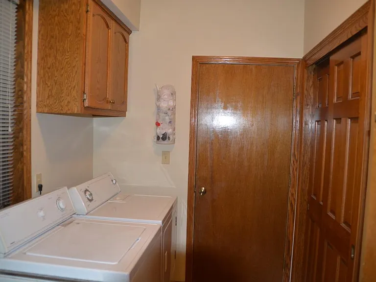 First-floor laundry room with a closet and garage entrance