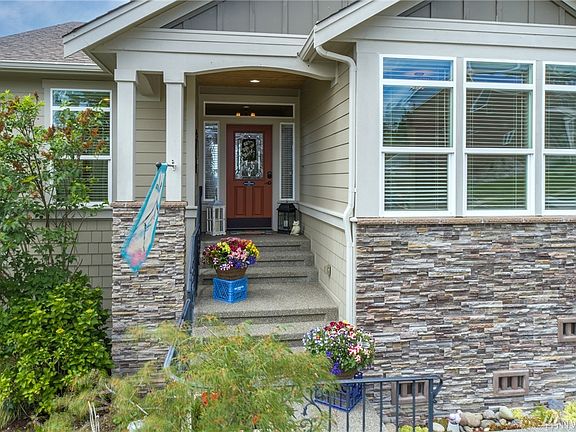 Welcome home! Inviting entry offers rock garden, wrought iron fence, stacked rock, custom door with obscure glass and side lights, car decking and aggregate concrete. Surrounded by beautiful landscaping that will flower from Spring through Summer. 