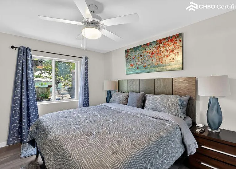 Spacious primary bedroom with king bed and natural light