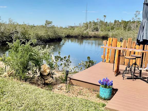 Outside a special sitting area of Cedarwood table umbrella invites you to enjoy your meals while overlooking the water