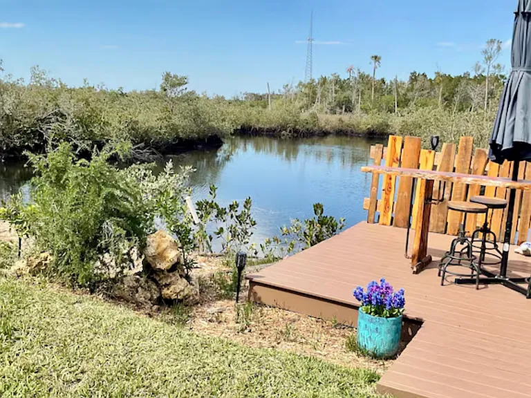 Outside a special sitting area of Cedarwood table umbrella invites you to enjoy your meals while overlooking the water