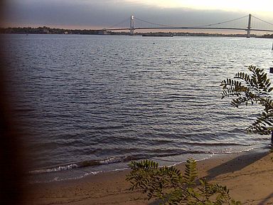 view of beach and bridge from backyard