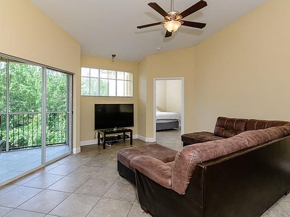 Spacious Living Room (15.2'x16.4') Offers a Wooded View, Vaulted Ceilings, & Lots of Natural Light!