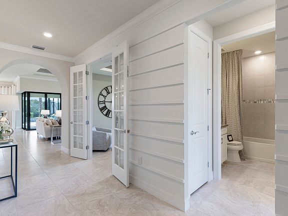 Foyer Leading to Secondary Bedroom and Den with French Doors