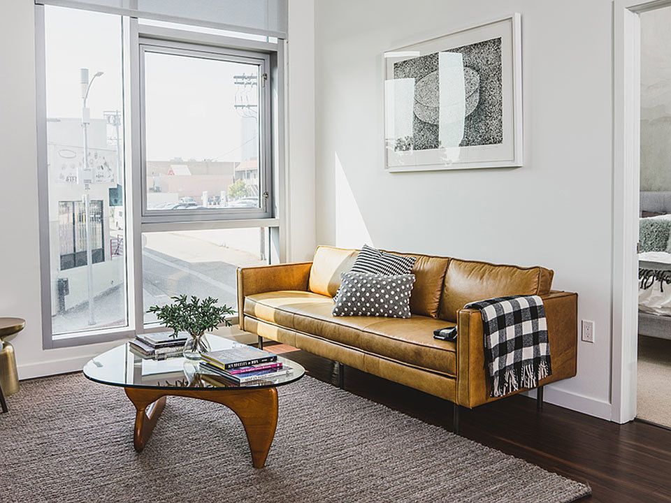 Bright lit open floor plans featuring sustainable hardwood flooring