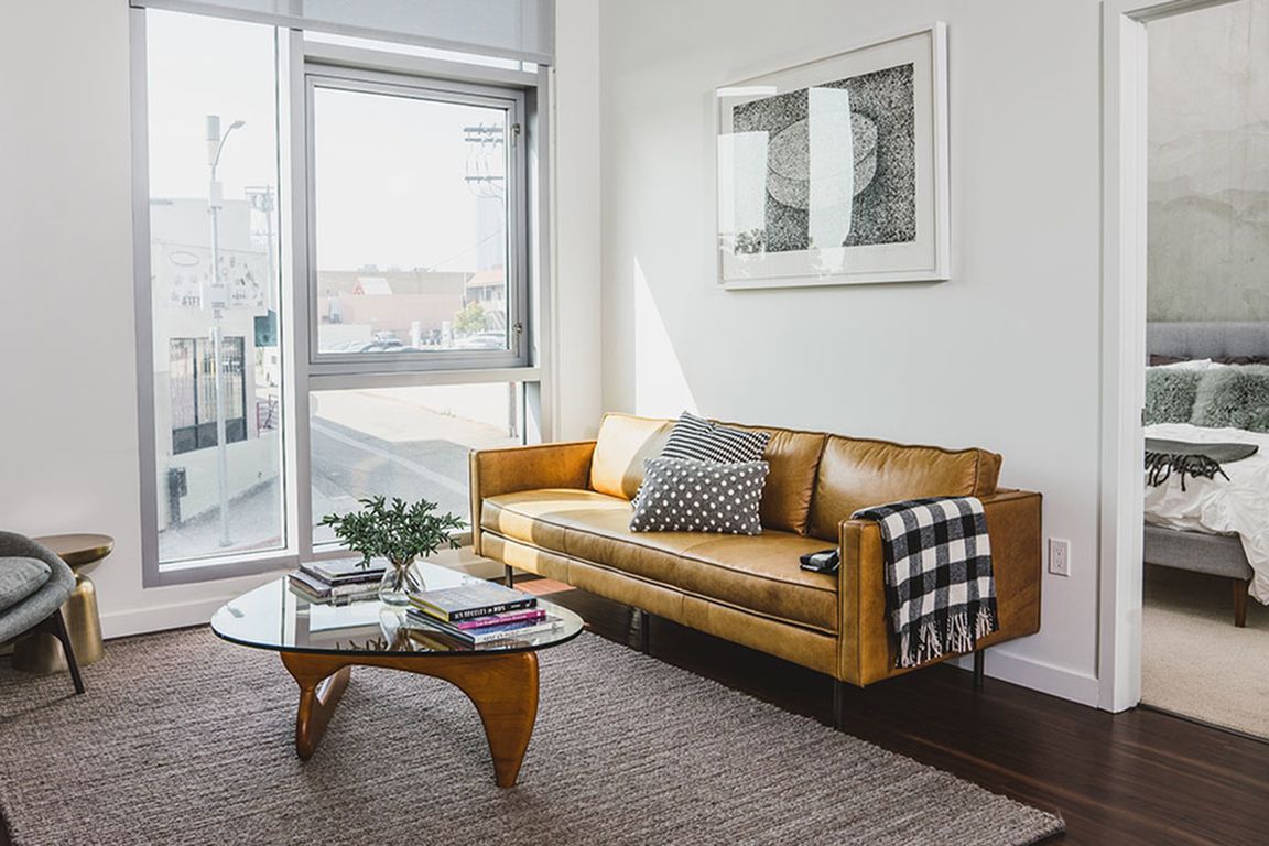 Bright lit open floor plans featuring sustainable hardwood flooring