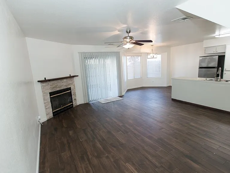 Open floor plan for living/dining room with gas fireplace.