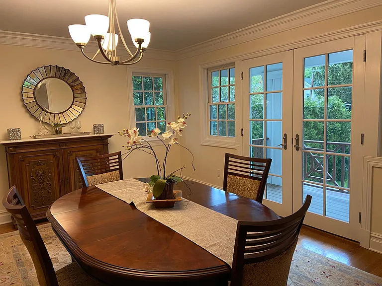 Dining room with door to kitchen, also has French doors to front decking. This house gets lots of light even in the fall and winter.
