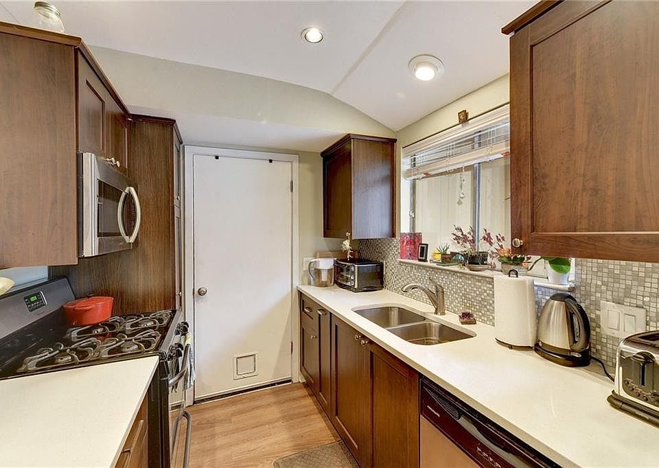Updated Kitchen Cabinets, Countertops with Top Brand Appliances. Kitchen Door with Private Entry and Exit Through Attached Garage.