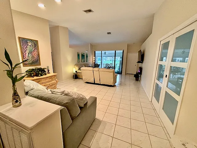 View from entryway - lake in the distance; office w/Queen bed behind glass sliding doors to the right