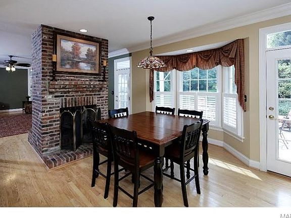 A bay window lights up the breakfast area and its side of the fireplace.