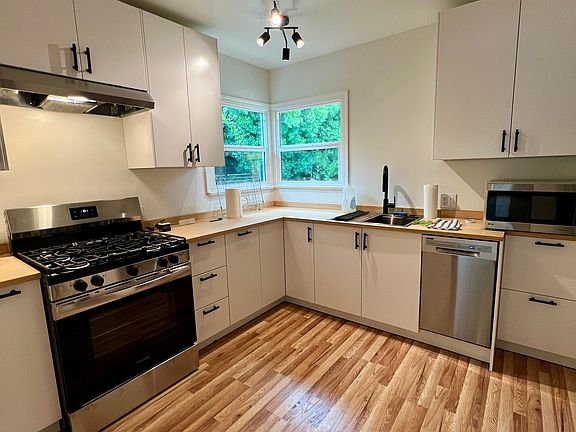 Complete with garbage disposal, dishwasher, range and hood and stainless refridgerator.