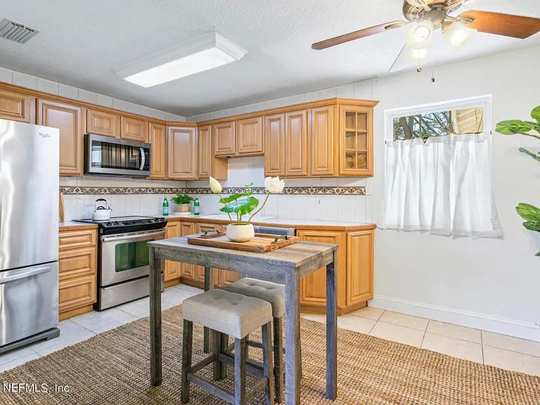 Kitchen. Connects to living room, dining, and sitting area with fireplace.